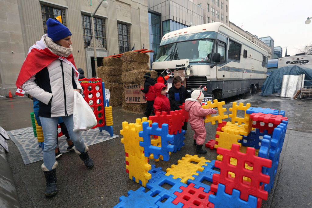 Children play at a make shift playground during the Freedom Convoy protests on February 8, 2022 in Ottawa, Canada. Photo credit: Dave Chan / AFP via Getty Images